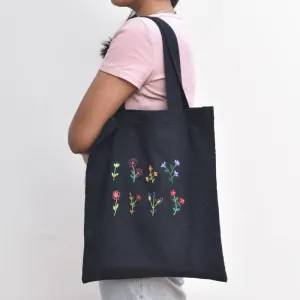 Black canvas tote bag with small flower embroidery